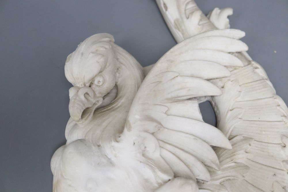 A carved white marble griffin, overall length 36cm (a.f.)